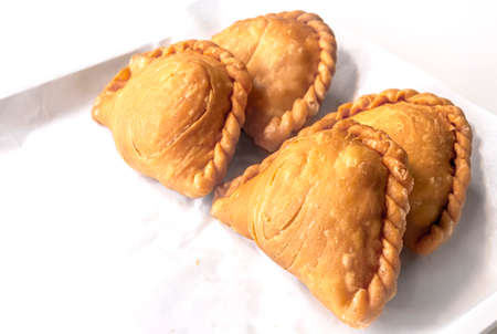 Curry puff pastry on white paper background.