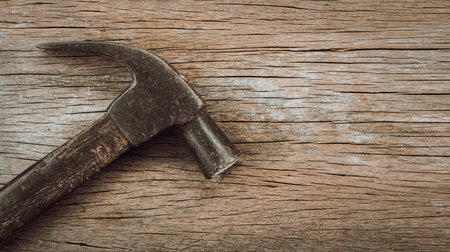 Old hammer on a wooden table with copy space for your text or images.の写真素材