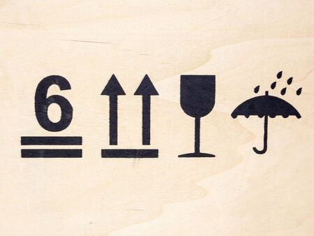 fragile symbol on woodの写真素材