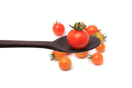 Ripe tomato in  spoonの写真素材