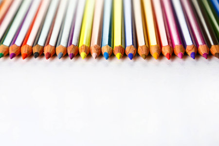 color pencils in row on white paper backgroundの写真素材