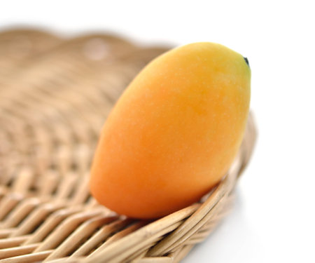 Sweet Marian plum fruit in basket on white background
