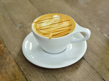 Coffee latte art on wood table
