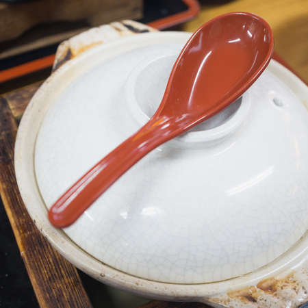 red spoon on the bowl ready for mealの写真素材
