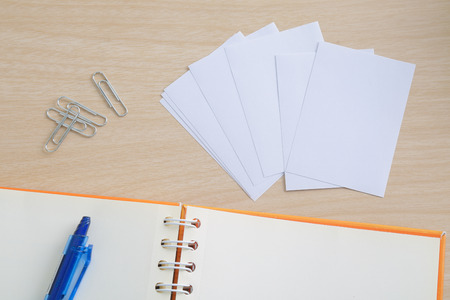 pen and notebook on wood tableの写真素材