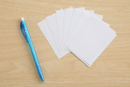 pen with note paper on wood tableの写真素材