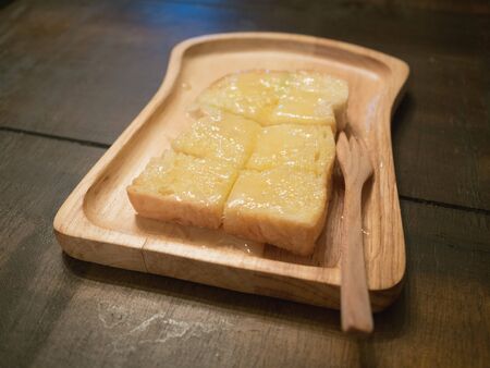buttered toast with wood trayの写真素材
