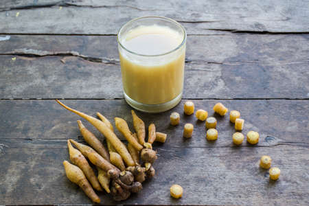 Herbal drink glass Kaempferia extracts and Fresh Krachai root with Fresh sliced Kaempferia is placed...