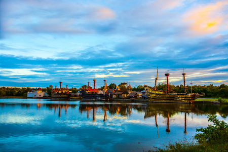 Old Brig In the water near the ancient Thai house. Evening at sunset.の写真素材