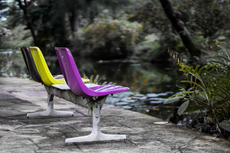 Old plastic chair is located in the middle of the garden.の写真素材