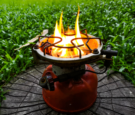 Old camping stove Was left on a green lawn.の写真素材