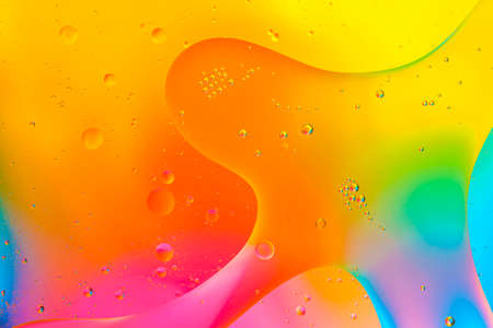 Colorful of oil drop floating on the water.Fantastic structure of colorful oil bubbles.