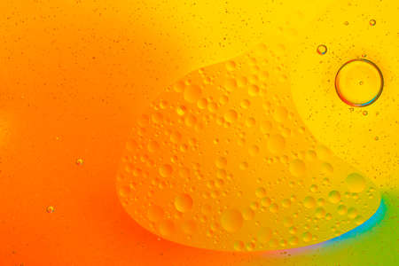Colorful of oil drop floating on the water.Fantastic structure of colorful oil bubbles.
