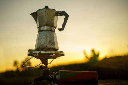 antique coffee pot On the gas stove for camping when the sun rises in the morning.soft focus.の写真素材