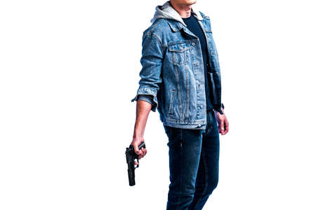 Man in a denim jacket holding a handgun on a white background.の写真素材