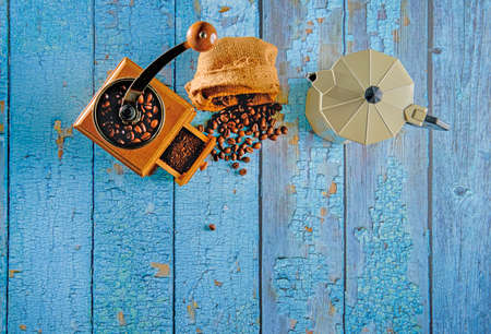 Vintage coffee grinder.Old retro hand-operated wooden and metal coffee grinder.Manual coffee grinder for grinding coffee beans. on the old wooden background.soft focus.の写真素材