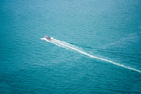 KRABI, THAILAND - Thai wooden motorboat, boat trips at sea, Clean white sand beaches, and emerald green sea.の写真素材