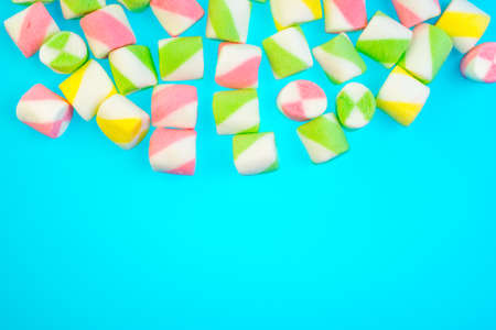 Background or texture of colorful blue and pink marshmallows.Multi-colored marshmallows on a blue backgroundの写真素材