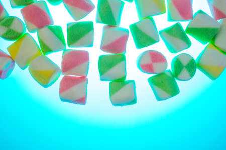 Background or texture of colorful blue and pink marshmallows.Multi-colored marshmallows on a blue backgroundの写真素材
