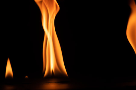 burning power of the flame, Flames, and burning sparks close-up, fire patterns, the glow of fire in the darkの写真素材