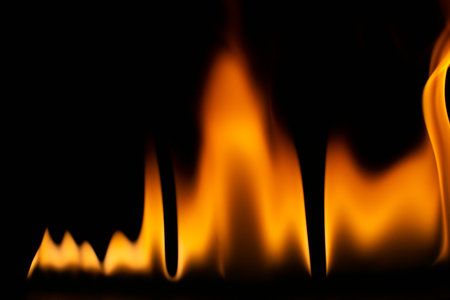 burning power of the flame, Flames, and burning sparks close-up, fire patterns, the glow of fire in the darkの写真素材