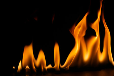 burning power of the flame, Flames, and burning sparks close-up, fire patterns, the glow of fire in the darkの写真素材