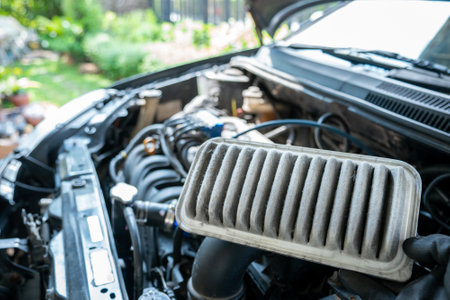 Concept of car care service maintenance, the car air filter is old and dirty with dust stains for checking cleaning and replacing the new filter.の写真素材