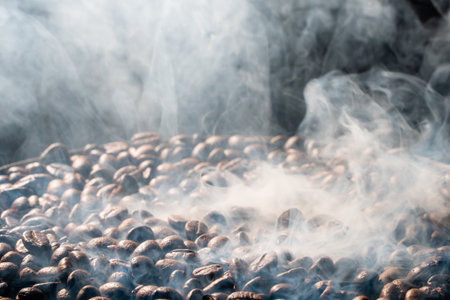 Coffee beans roasting with smoke,  selective focus, and soft focus.の写真素材