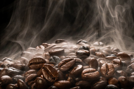 Coffee beans roasting with smoke,  selective focus, and soft focus.