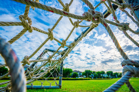 Rope net goal, mini soccer field with green grass Simple, old-fashioned miniature mosquito nets...