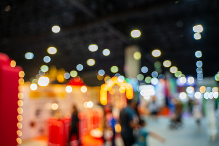Blurred images of trade fairs in the big hall. image of people walking on a trade fair exhibition or expo where business people show innovation activity and present products in a big hall.の写真素材