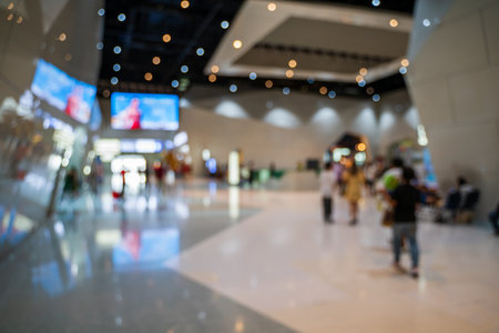 Blurred images of trade fairs in the big hall. image of people walking on a trade fair exhibition or...