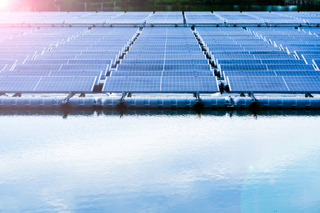 Side view of solar panels floating on water in a lake, for generating electricity from sunlight,...