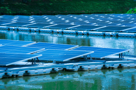 Side view of solar panels floating on water in a lake, for generating electricity from sunlight, selective focus, soft focus.の写真素材
