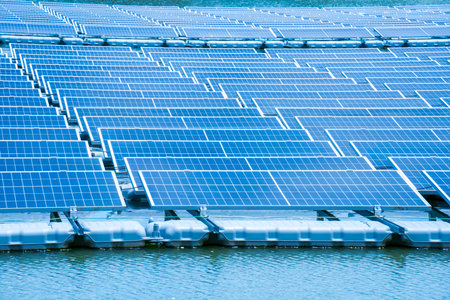 Side view of solar panels floating on water in a lake, for generating electricity from sunlight, selective focus, soft focus.の写真素材