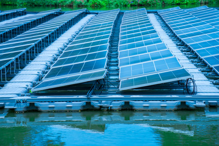 Side view of solar panels floating on water in a lake, for generating electricity from sunlight, selective focus, soft focus.の写真素材