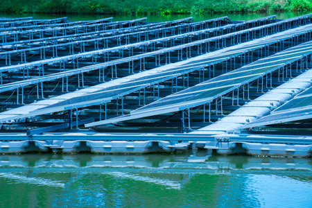 Side view of solar panels floating on water in a lake, for generating electricity from sunlight, selective focus, soft focus.の写真素材