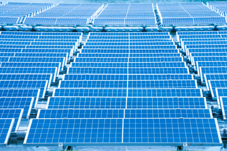 Side view of solar panels floating on water in a lake, for generating electricity from sunlight, selective focus, soft focus.の写真素材