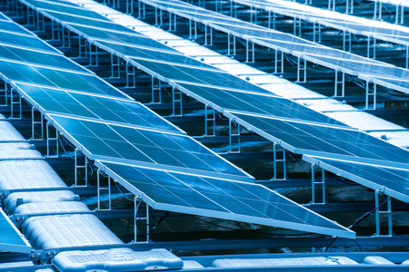 Side view of solar panels floating on water in a lake, for generating electricity from sunlight, selective focus, soft focus.の写真素材