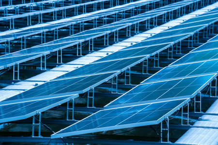Side view of solar panels floating on water in a lake, for generating electricity from sunlight, selective focus, soft focus.の写真素材