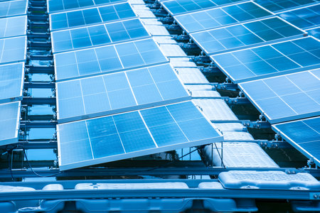 Side view of solar panels floating on water in a lake, for generating electricity from sunlight, selective focus, soft focus.の写真素材