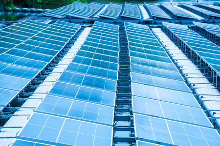 Side view of solar panels floating on water in a lake, for generating electricity from sunlight, selective focus, soft focus.の写真素材