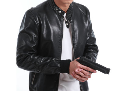 man holding a gun like a secret agent on a white backgroundの写真素材