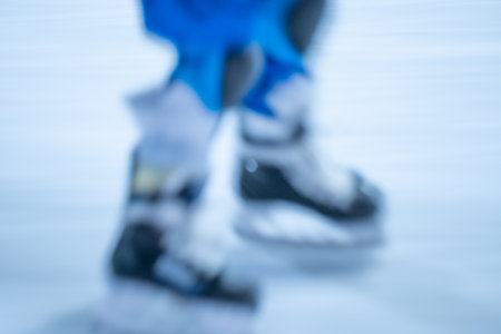 Blurred movement of skates on an outdoor ice rink. Young girl skating thinking on the open rinkの写真素材