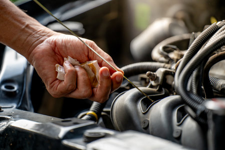 Drivers are Pulling the engine oil level dipstick To check the quality of engine oil. transportation conceptの写真素材
