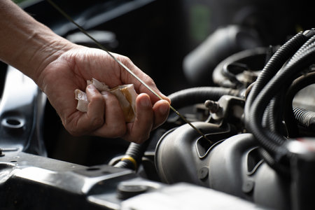 Drivers are Pulling the engine oil level dipstick To check the quality of engine oil. transportation conceptの写真素材