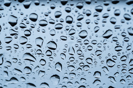 Rain drops cling to the car windshield, selective focus, soft focus.の写真素材