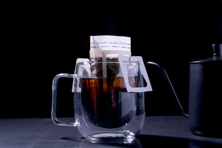 Drip coffee and pour water on the black stone table, soft focus.shallow focus effect.の写真素材