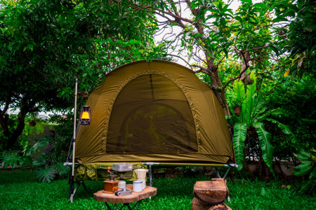 camping tents with outdoor coffee-making facilities on wooden tables in a forest camping area in the forest.の写真素材