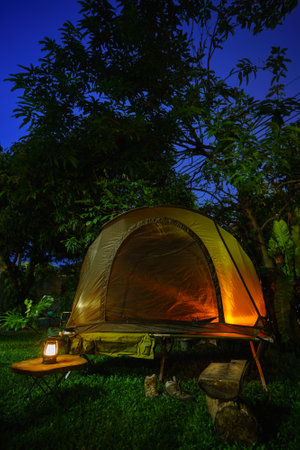 camping tents with outdoor coffee-making facilities on wooden tables in a forest camping area in the forest.の写真素材